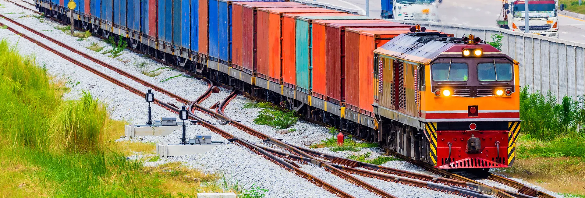 Block train carrying large containers along the Trans-Asian Railway, ready for departure.