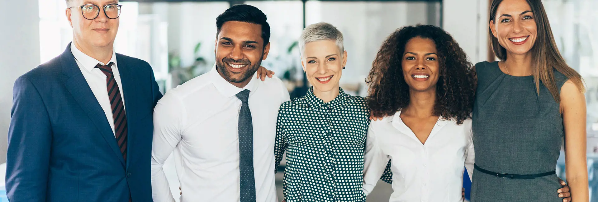 Diverse team of professionals smiling, representing Scan Global Logistics' DNA and values