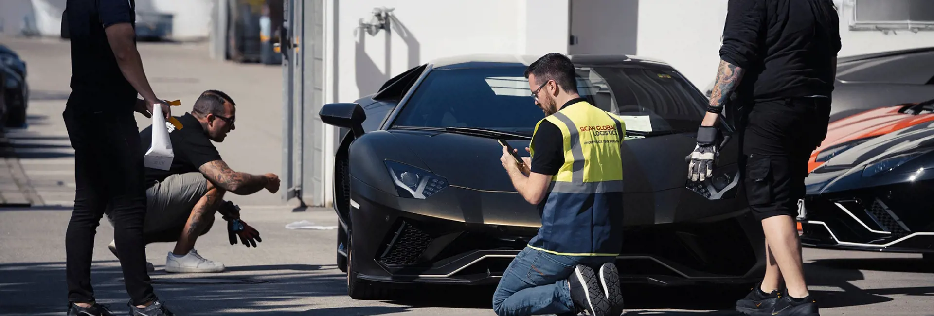 Scan Global Logistics team inspecting a luxury car as part of automotive logistics services