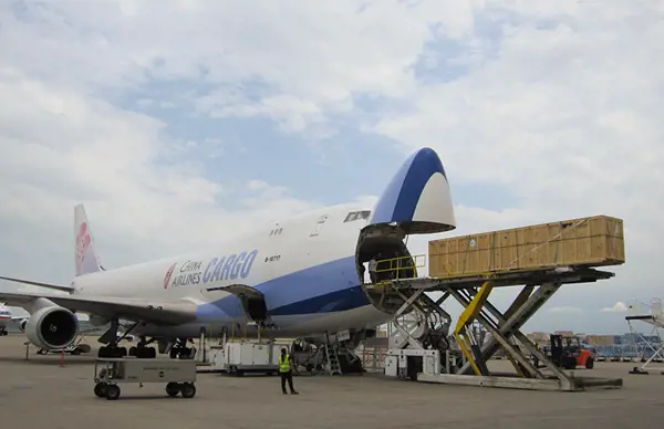 China Airlines Cargo plane being loaded with a large wooden crate using a hydraulic platform on the tarmac