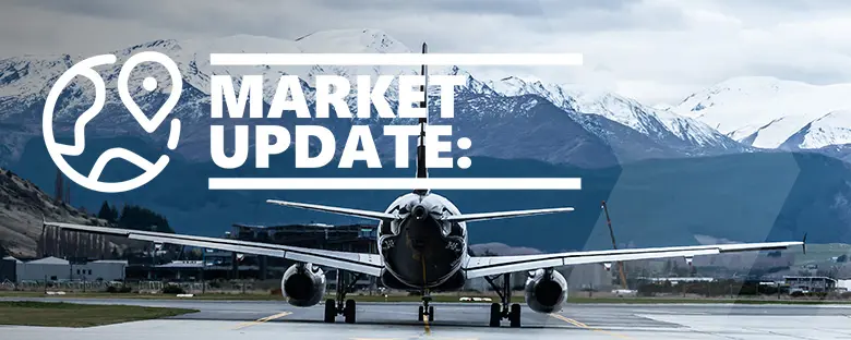Commercial airplane on runway with 'Market Update' text overlay, mountains in background