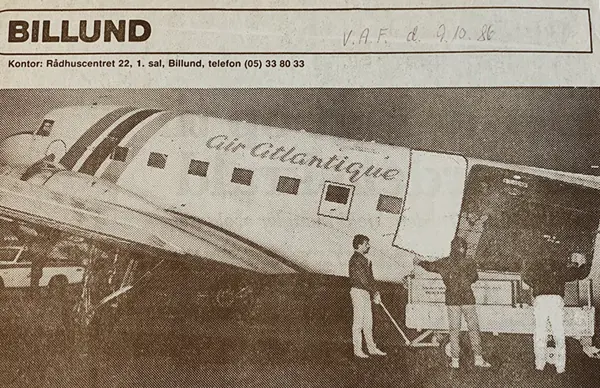 Historic newspaper photo of an Air Atlantique plane being loaded with cargo, highlighting Scan Global Logistics' early days in Billund