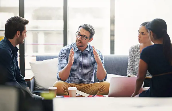 A sustainability advisor leading a discussion with a team, representing Scan Global Logistics' expert guidance on supply chain decarbonization