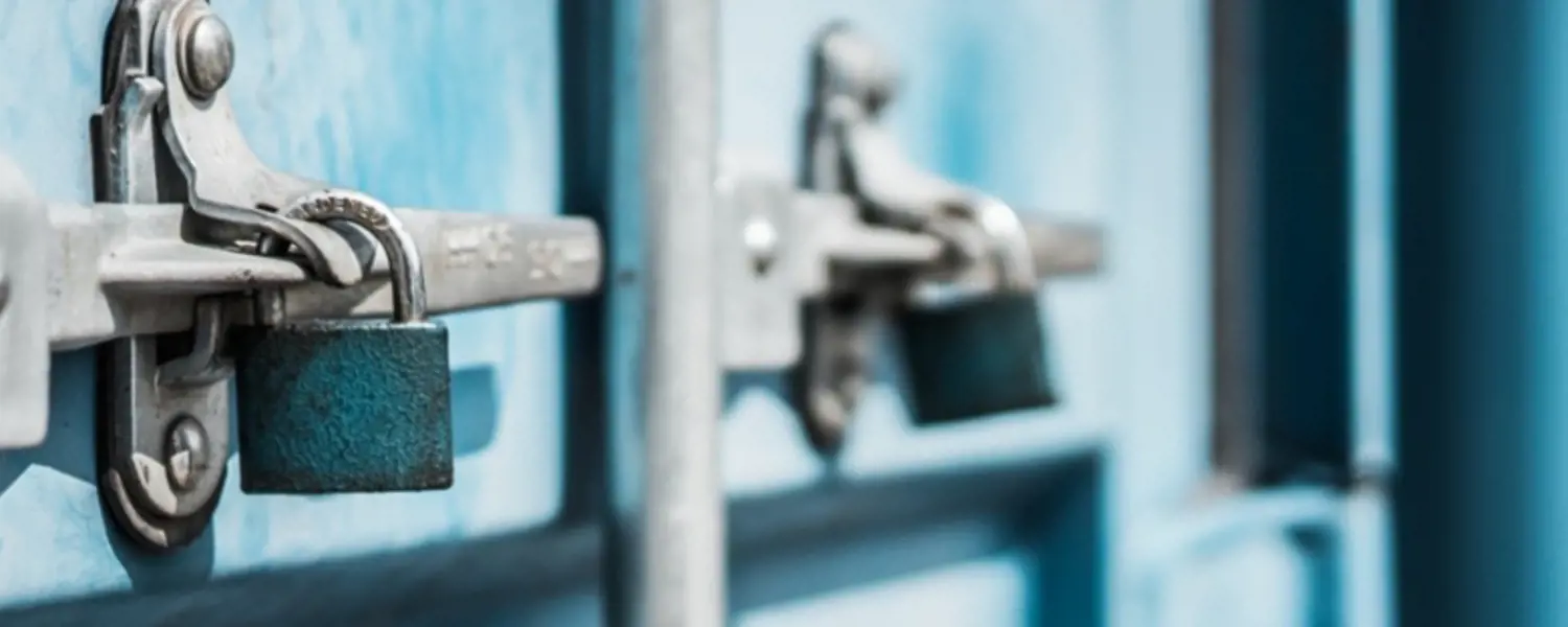 A closeup of the doors of a blue shipping container 